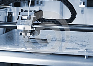 3D printer prints the form of molten plastic blue close-up