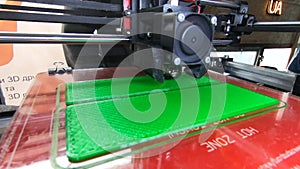 3D printer. working 3d printer. 3d printer printing object molten plastic.
