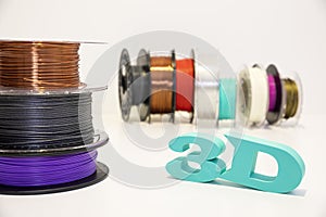 3D printing filament reels for 3d printers with text `3d` on white background