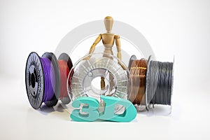 3D printing filament reels with wooden anthropomorphic doll with text `3d` on white background