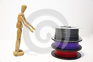 3D printing filament reels with wooden anthropomorphic doll on white background