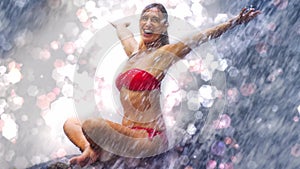 3d render glowing flare particles and shimmer on young beautiful and happy woman in bikini enjoying tropical waterfall