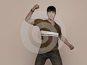 3D Render : Portrait of a smiling young handsome asian man in brown T-shirt and jeans