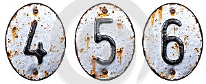 3D render set of numbers 4, 5, 6 made of forged metal on the background fragment of a metal surface with cracked rust.