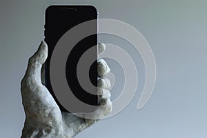 3d rendered stone sculpture hand holding a smart phone, electronic device concept, isolated on grey background, minimal modern