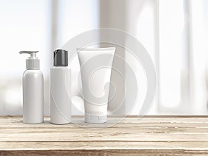 3d rendering of blank white mockup cosmetic set a pump lid bottle, a flip lid bottle and a squeeze tube on an wooden