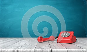 3d rendering of a bright red dial phone standing on a wooden desk and a blue wall background.