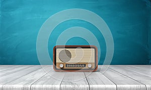 3d rendering of a brown vintage radio set standing on a white wood table in front of blue background.