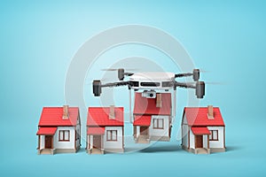3d rendering of camera drone carrying small cottage and putting it down in a row with other 3 identic cottages on light
