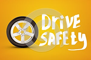 3d rendering of car wheel and white title `Drive safety` on amber background.