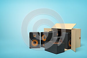 3d rendering of cardboard box lying sidelong with black audio speakers inside and three outside on light-blue background