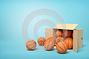 3d rendering of cardboard box lying sidelong full of basketballs on light-blue background.