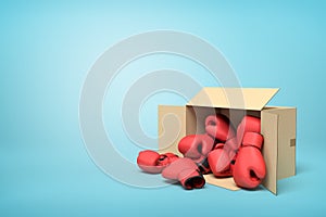 3d rendering of cardboard box lying sidelong full of red boxing gloves on light-blue background with much copy space.