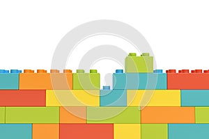3d rendering of colorful wall made of many toy bricks with one piece staying unused on white background.