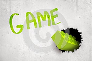 3d rendering of concrete wall with title `GAME` and bright green lego brick that has been thrown into wall and has