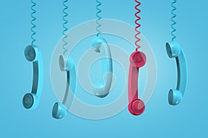 3d rendering of five old-fashioned phone receivers hanging down on their wires, one red, the others turquois, on