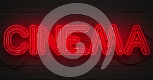 3D rendering flickering blinking red neon sign on dark brick background, cinema movie film entertainment sign