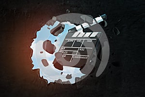 3d rendering of movie clapper breaking black wall