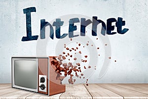 3d rendering of old TV set which starts to break into pieces near wall with title `Internet`.