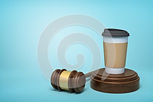 3d rendering of paper coffee cup standing on sounding block with gavel lying beside on light-blue background with copy
