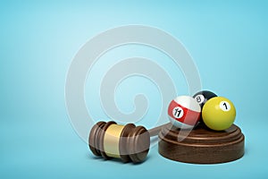 3d rendering of pool and billiard balls on round wooden block and brown wooden gavel on blue background