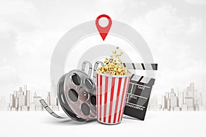 3d rendering of popcorn bucket, film reel, movie clapper on white city skyscrapers background