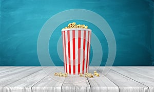 3d rendering of popcorn bucket on wooden surface near blue wall with copy space.