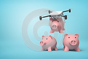 3d rendering of quadcopter carrying pink piggy bank and putting it down to two identic piggy banks standing on light