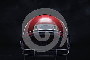 3d rendering of a red American football helmet with its front guard on a dark background.
