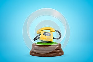 3d rendering of ringing yellow rotary phone inside glass ball globe on light blue gradient background.