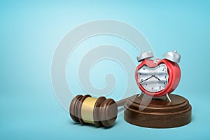 3d rendering of smashed broken alarn clock on round wooden block and brown wooden gavel on blue background