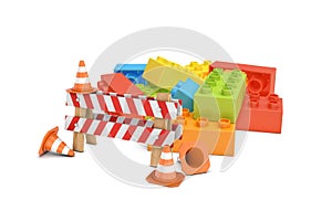 3d rendering of a striped roadblock sign beside several traffic cones standing in front of a colorful lego blocks pile.