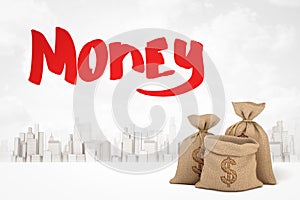 3d rendering of three canvas money bags with dollar symbols and red title `Money` against white background of modern