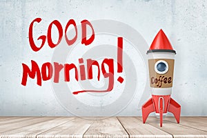 3d rendering of toy rocket made of coffee paper cup, standing on wooden floor, near wall with title `Good Morning`