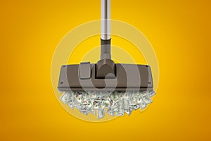 3d rendering of vacuum cleaner floor brush that is sucking in a heap of dollar banknotes on amber background.