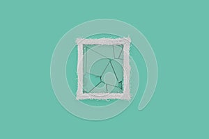 3d rendering of white picture frame with shattered glass laying on cyan background and embraced with wire