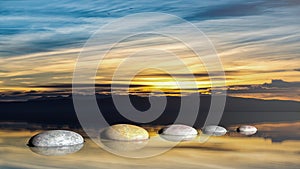 3D rendering of Zen stones in water with sunset sky