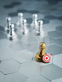 3d target icon with golden pawn standing out from the group of silver pawn chess pieces on hexagon pattern background.