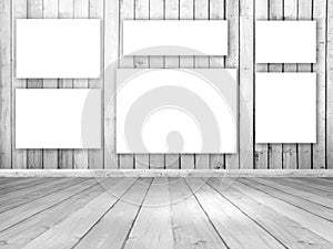 3D wooden room interior with blank hanging canvases