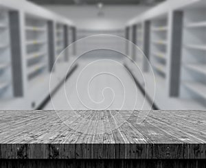 3D wooden table looking out to a defocussed empty supermarket