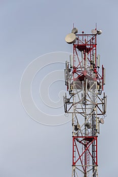 3G, 4G, 5G, wireless and cell phone telecommunication tower close-up on cloudy daylight sky background