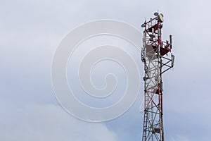 3G, 4G, 5G, wireless and cell phone telecommunication tower close-up on cloudy daylight sky background with copy space