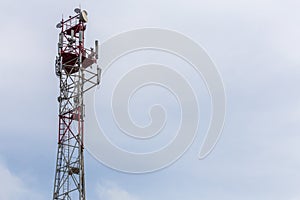 3G, 4G, 5G, wireless and cell phone telecommunication tower close-up on cloudy daylight sky background with copy space