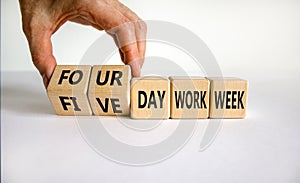 4 or 5 day work week symbol. Businessman turns cubes, changes words `five day work week` to `four day work week`. Beautiful wh