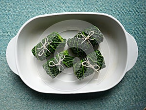 4 Cabbage rolls. Cabbage, a vitamin-rich main course. Close up,  on white background