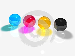 4 CMYK glass balls on a white background.