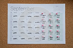 4 day work week printed calendar with pink pins on three days off in week weekend days four day working week concept