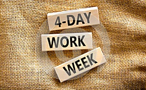 4-day work week symbol. Concept words 4-day work week on wooden blocks on beautiful canvas table, canvas background. Copy space.