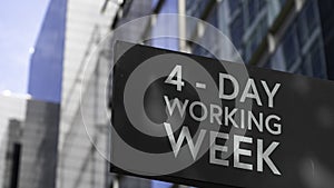 4 - Day working week on a black city-center sign in front of a modern office building