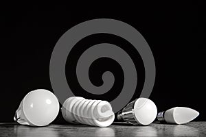 4 different e27 household light bulbs on a black background with copy space